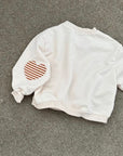 Heart Patch Sweatshirt – Oversize Pullover mit Detail
