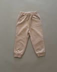 Beige Jogginghose – Bequeme Hose mit elastischem Bund und Bündchen am Beinabschluss.