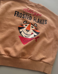 Nahaufnahme des „Frosted Flakes“ Prints auf dem Rücken – Tony der Tiger mit einer Schüssel Cornflakes und dem Schriftzug „Frosted Flakes“.