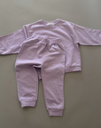 Lilac Sweat Set – Pullover und Jogginghose locker drapiert für einen entspannten Look.