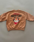 Beiges Sweatshirt mit großem „Frosted Flakes“ Print auf dem Rücken – zeigt Tony den Tiger mit einer Schüssel Cornflakes und der Aufschrift „Frosted Flakes“.