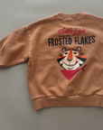 Beiges Sweatshirt mit großem „Frosted Flakes“ Motiv auf dem Rücken – lockerer Schnitt, gerippte Bündchen.